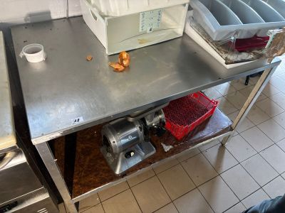 a metal table that has a bunch of items on it