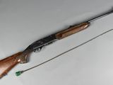 the rifle is laying on the table next to the string