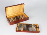 two sets of knives in a case on the table