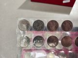 a box of coins sitting on a table next to a box of coins