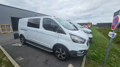 the white van is parked in the parking lot next to the building