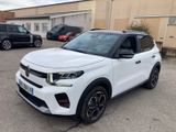 a white suv parked in a parking lot next to other cars