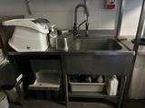 a kitchen with a stainless steel sink and a dishwasher