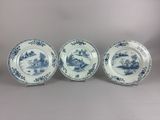 three blue and white plates with designs on them sitting on a table