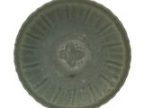une assiette verte ornée d'un motif sur fond blanc