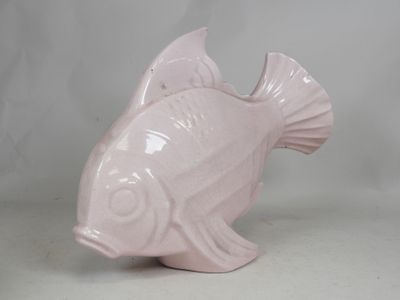 a pink ceramic fish that is sitting on a table