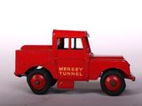 a red toy truck that is sitting on a white surface