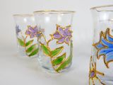 three glass vases with flowers painted on them