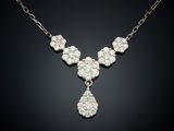 a diamond necklace on a black background