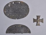 two metal plaques with a cross on one of them and a cross on the other