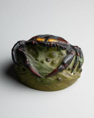 a crab that is sitting on top of a bowl