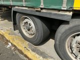 un camion vert et jaune garé sur le bord de la route