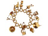 an image of a gold bracelet with various charms on a white background