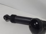 a close up of a black ball on a white surface