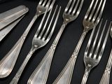 a lot of forks and spoons that are on the table