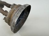 a metal bell that is sitting on a white surface