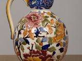 a vase with a floral design on it sitting on a table