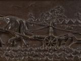a metal plaque with a horse drawn carriage on it