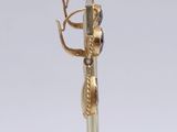 a gold and silver pen with a snake on top of it