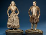 pair of carved figurines of a man and woman