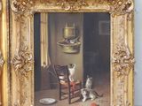 two framed pictures of cats sitting on a chair