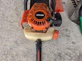 a picture of a chainsaw and a hedger on the ground