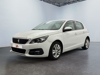 the white car is parked in a large white room