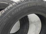 tires are lined up on the floor next to a white wall