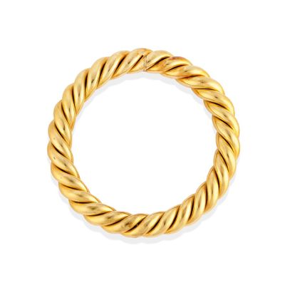 a gold twisted ring on a white background