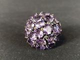 a close up of a purple ring on a black surface