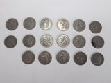 a close up of a bunch of coins sitting on top of a white surface