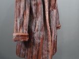 a brown and black fur coat on a mannequin stand