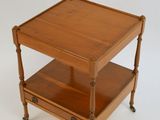 a small wooden table with a shelf on it
