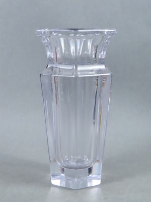 a clear glass vase with a silver lid on a table