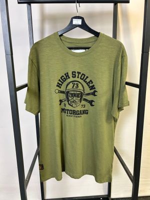 La chemise verte est suspendue à un portant dans une pièce.