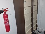a fire extinguisher in the corner of a room