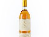 the bottle of wine is sitting on a white surface