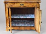 a small wooden cabinet with a bed underneath it