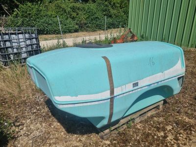un bateau bleu posé par terre dans la cour