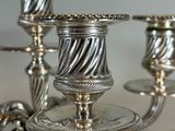 two silver candles that are sitting on a table