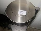 a metal pan sitting on top of a toilet in a bathroom
