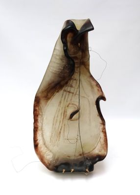 a brown and white vase with a face on it
