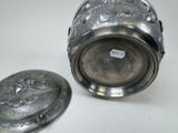 a silver container with a lid sitting on a table