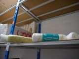 a shelf with rolls of toilet paper and a roll of toilet paper on it