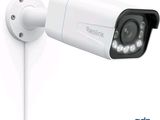 a white security camera attached to a white wall