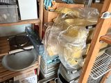 a kitchen with a lot of clutter on the shelves