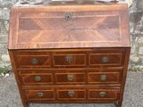 a wooden dresser with drawers and drawers on top of it