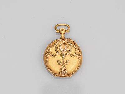 a gold pocket watch with a floral design on the dial