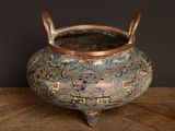 a small pot with a handle on a wooden table