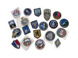 a pile of military patches and badges on a white surface